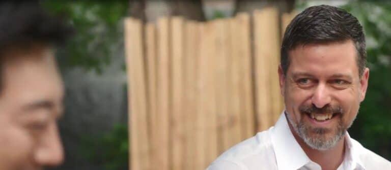 Smiling professional in a business meeting, representing expertise and trusted partnerships.