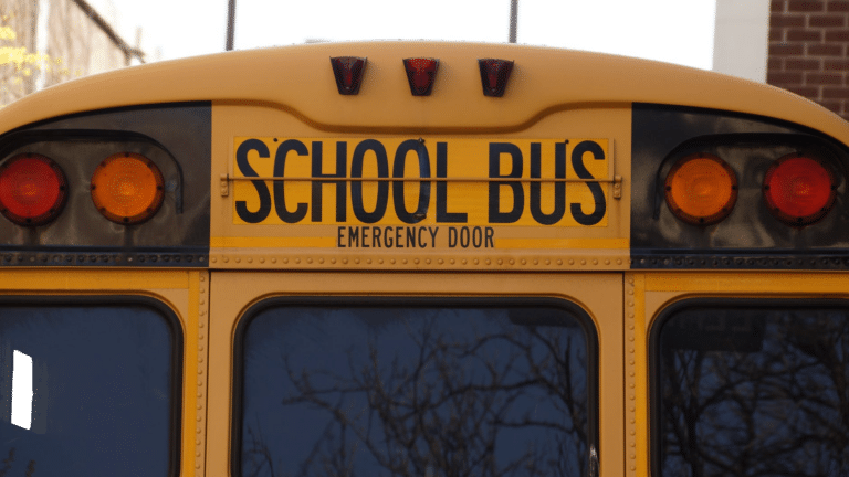 Rear view of a yellow school bus, symbolizing the connection between raising smart kids and creating smart homes.