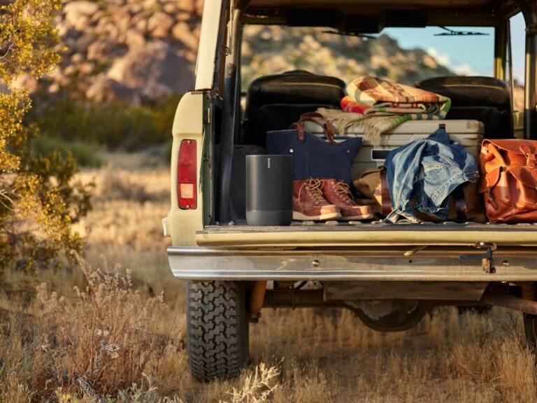Outdoor adventure scene with gear packed in a vehicle trunk, featuring the Sonos Move as part of portable home audio systems.
