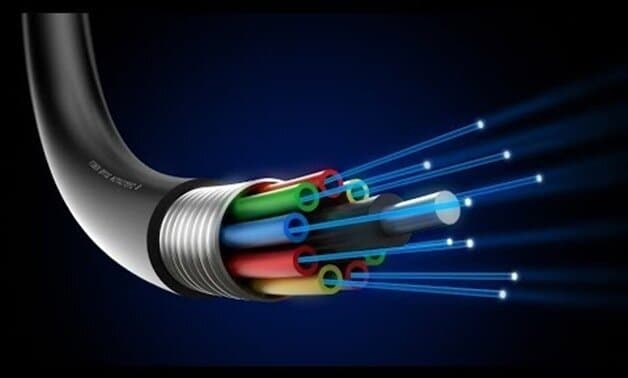 A close-up digital rendering of a fiber optic cable, showing multiple colored inner tubes with beams of light emerging from the ends, symbolizing high-speed internet data transmission. The background is a dark gradient, highlighting the futuristic and high-tech concept of fiber optics.