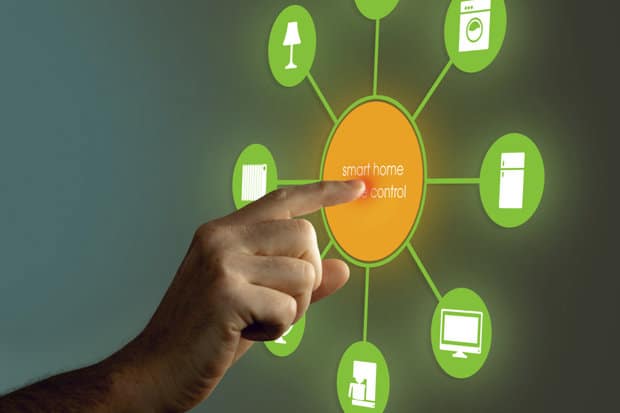 A hand interacting with a digital smart home control interface displaying connected devices.