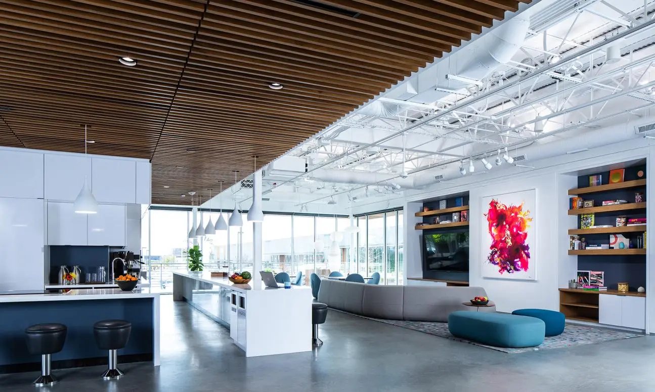 Bright kitchen and lounge at Ketra headquarters under a wood ceiling