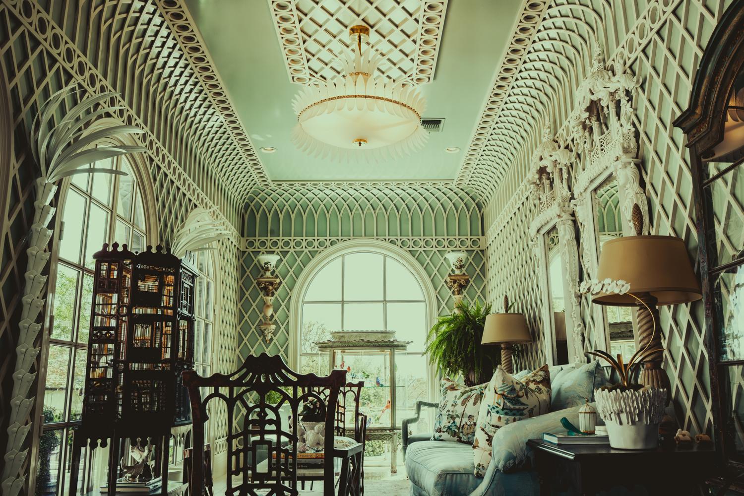Sunroom with a green lattice ceiling, chandelier and arched windows