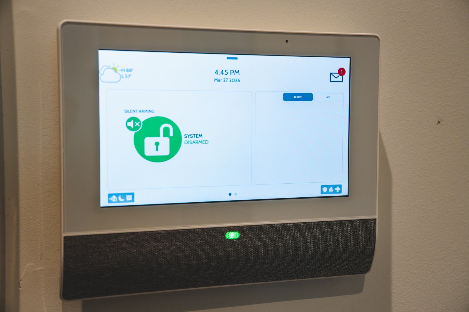 Wall-mounted security touchscreen showing the system as disarmed
